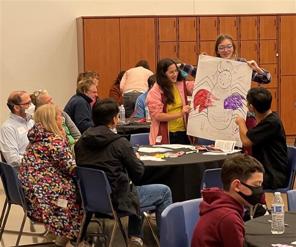 Prospective students share their drawing with other families.